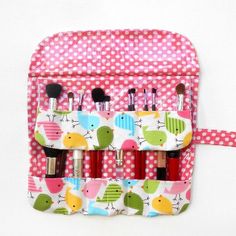 This is a fun bird print with a coordinating pink with white polka dot print makeup brush holder.  Perfect to store and organize all of your brushes, eyeliners, lip pencils, mascara, etc.  I have placed clear vinyl behind all of the pockets so all you have to do to keep your holder looking new is wipe with a damp cloth. Great to pop in your purse or suitcase or to give as a gift! Please note that supplies shown are not included. There are 2 rows with 6 pockets in each row.  These pockets range in size from 1 1/4" to 2 1/2" so you may fit several items in each pocket.  The bottom row can accommodate items that are up to 9 1/2" in length, and the top row can accommodate items that are up to 5 1/8" in length. The top flap folds down to keep everything in place.   Height with flap closed is 10 Makeup Brush Roll, Makeup Brush Case, Brush Storage, Makeup Brush Holder, Cosmetic Brush, Brush Roll, Pink Bird, Makeup Brush Holders, It Cosmetics Brushes