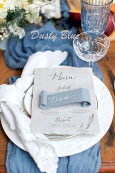 a place setting with blue napkins and silverware