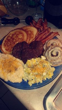 a blue plate topped with breakfast foods on top of a counter