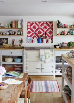 the kitchen is decorated with red and white quilts