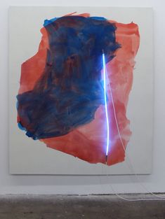 an abstract painting with blue and red colors on the wall next to a white floor