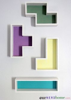 three white shelves with different colored sections on the top one is shaped like a cross