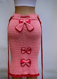 a crocheted skirt with bows on the side