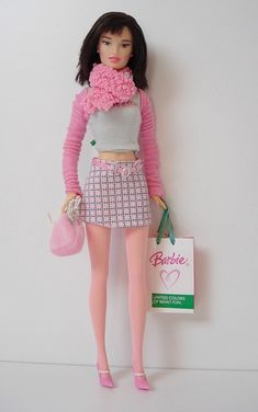 a barbie doll is holding a shopping bag and posing for the camera with pink tights