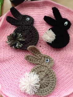 three crocheted animals sitting on top of a pink plate