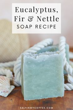 a soap bar sitting on top of a wooden table next to seashells and rope