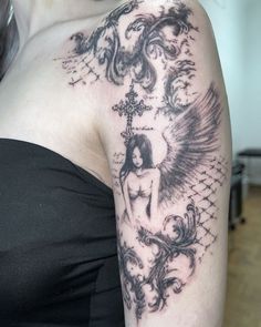 a woman with an angel tattoo on her arm