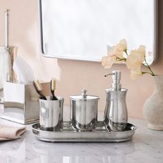 a bathroom sink with a mirror and soap dispenser on top of it