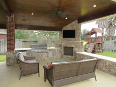 an outdoor living area with grill and seating