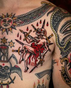 a man with tattoos on his chest holding two swords and an angel in the center