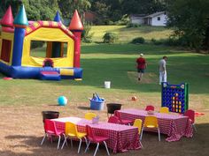 an inflatable bouncy house set up with tables and chairs