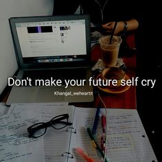 a laptop computer sitting on top of a desk next to a cup of coffee and pen