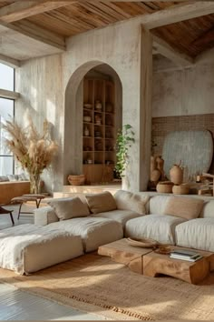 a living room filled with furniture and lots of windows