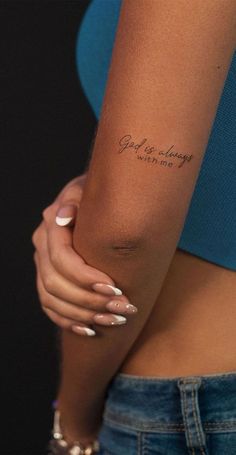 a woman's arm with a tattoo that reads, god is always waiting for me