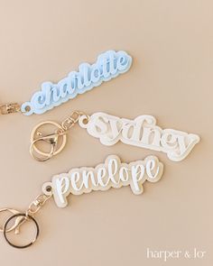 three keychains with the words charlotte, sidney, pineapple on them