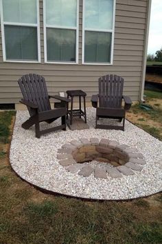 an outdoor fire pit surrounded by chairs and gravel in front of a house with windows