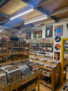 the inside of a record store with many records on shelves and various cd's