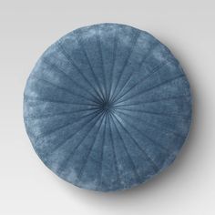 a blue round pillow with an intricate design