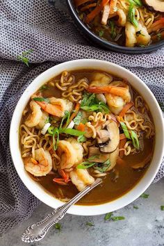 two bowls of shrimp noodle soup on a table