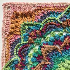 a crocheted square with many different colors and designs on it's edges