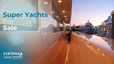 a person walking down a wooden walkway next to boats