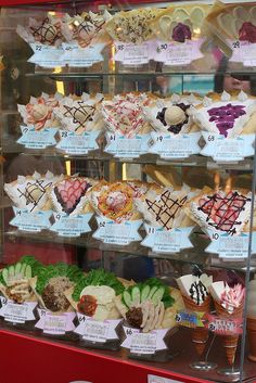 a display case filled with lots of different types of pastries and desserts on it