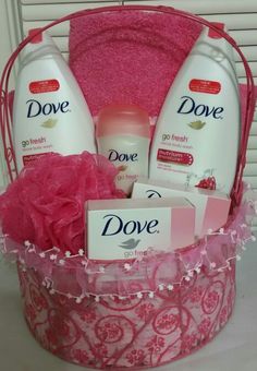 a pink gift basket with dove products in it