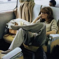 a woman sitting on a bus with her legs crossed