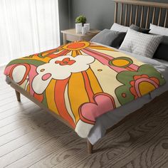 a bed with a colorful comforter on top of it