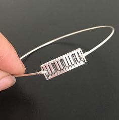 "Piano Bracelet - Keyboard Jewelry - Piano Player Gift A silver tone piano charm has been transformed into a piano bangle bracelet with bangle band choice of silver filled or sterling silver. The perfect gift for piano player or piano teacher gift. This piano bracelet stacks great with other bangles from my collection. Have fun stacking your piano jewelry for the ultimate layered look; http://www.etsy.com/shop/frostedwillow Personalize your piano bracelet with custom initial charms to create a c Piano Bracelet, Musical Bracelet, Piano Jewelry, Piano Teacher Gift, Teacher Gift Christmas, Piano Gifts, Christmas Piano, Music Teacher Gift, Metal Smithing