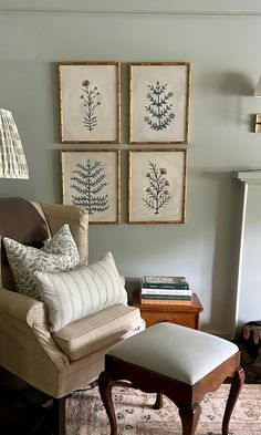 a living room filled with furniture and pictures on the wall