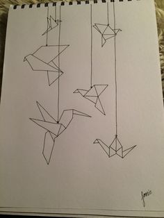 three birds hanging from strings on a sheet of paper with writing underneath them that reads, origami