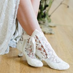 the bride's shoes are white with lace