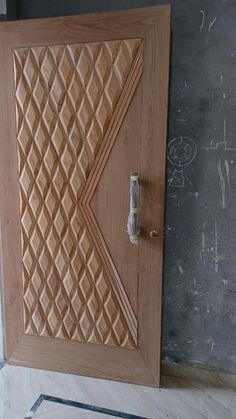 the door is made out of wood and has an intricate design on it's side