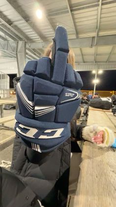 a person wearing a hockey goalie's helmet and gloves