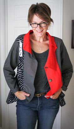 a woman standing in front of a door with her hands on her hips and wearing glasses