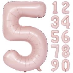 the number five is made out of pink foil balloons and numbers are arranged around it