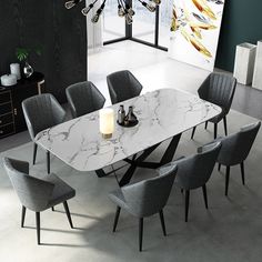 a dining room table with grey chairs and a chandelier