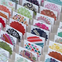 many different types of cards are displayed on a white surface with lots of colorful designs