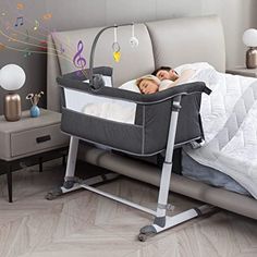 a woman laying in a baby crib on top of a bed next to a night stand