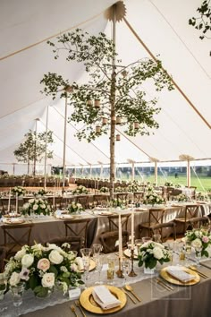 an outdoor tent with tables and chairs set up