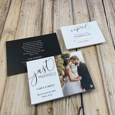 two wedding cards on top of a wooden table