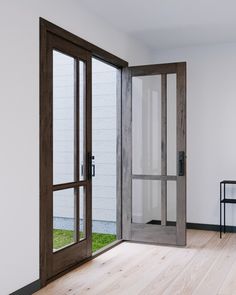 an empty room with wooden floors and glass doors