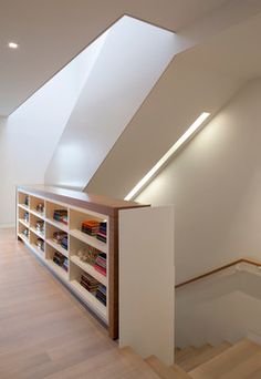 an empty room with bookshelves and stairs