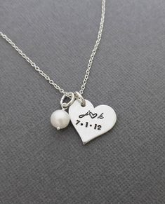 "« Personalized Necklace with Initials and Date // Anniversary Necklace // Hand Stamped Jewelry // Hand Stamped Necklace » Have this pretty heart pendant hand stamped with the initials and date of your choice to make the perfect gift! This necklace makes such a cute gift or keepsake and a cute way to carry a meaningful part of your life with you. The 3/4\" heart and freshwater pearl are hung from an 18\" oval link chain. Please let me know in the 'note to seller' box during checkout with the ini Heart-shaped Wedding Necklaces, Stamped Heart Jewelry For Anniversary, Dainty Stamped Charm Necklaces For Anniversary, Heart Shaped Stamped Jewelry For Anniversary, Heart-shaped Stamped Jewelry For Anniversary, Dainty Stamped Charm Necklace For Anniversary, Elegant Heart-shaped Stamped Necklace, White Charm Necklace For Wedding On Valentine's Day, Heart Necklace With Charms For Valentine's Day Wedding