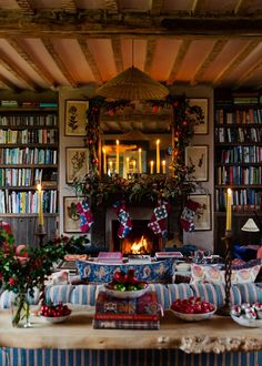 a living room filled with furniture and a fire place covered in books next to a fireplace