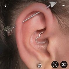 an ear piercing is shown with two small pieces attached to it