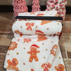 an assortment of gingerbreads and candy on display in front of a christmas tree