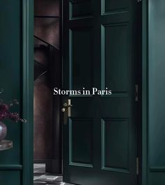 an open door with the words storm in paris on it and a vase full of flowers