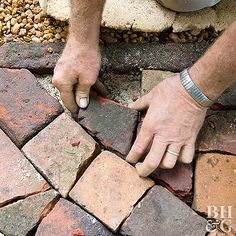 a man is placing bricks on the ground